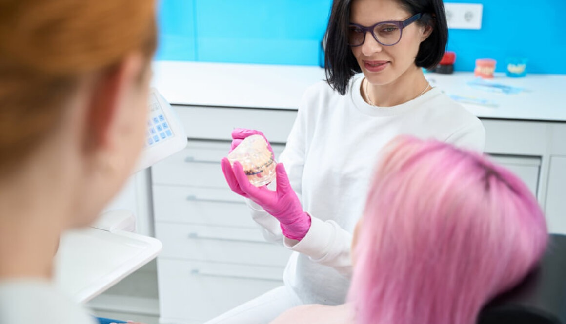 Patient is learning how to care for braces system